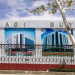 Uzbekistan: Nukus Billboard wall enclosing a building site with images of