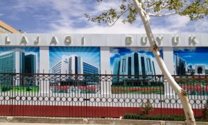 Uzbekistan: Nukus Billboard wall enclosing a building site with images of