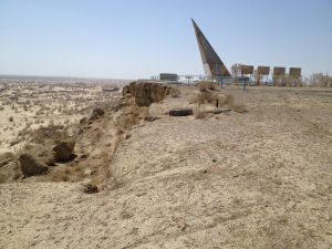 Uzbekistan: Muynak Aral Sea dry bed with rusting boats and monument.