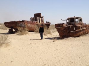 Uzbekistan: Muynak Michael at Aral Sea dry bed with rusting boats.