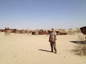 Uzbekistan: Muynak Richard at Aral Sea dry bed with rusting boats.