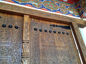 Uzbekistan: Margilan city carved entry door of the former madrassa school.