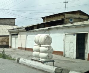 Uzbekistan: ????Margilan city???? bales of cotton for sale along the street.