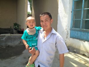 Uzbekistan: Fergana Valley, Rishton Mr. Bahrom with his youngest child.