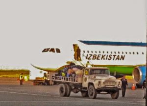 Uzbekistan: Nukus Unloading the inbound flight baggage with an old Russian