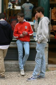 Portugal, Lisbon: kids, cell phones and jeans