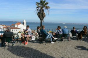 Portugal, Lisbon: tourist resting by the Tagus River view
