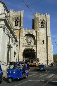 Portugal, Lisbon: cathedral with trolley and tuk-tuk