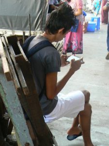 Burma, Rangoon: typical youth with cell phone