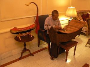 Burma, Rangoon; Gamelan musician in Strand Hotel