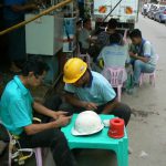Burma, Rangoon: workers break time with phones