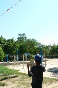 Burma, Mandalay: boy flying his kite