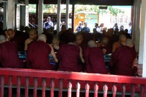 Monks eating breakfast;  each one carries and washes his own
