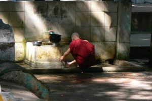 Burma, Mandalay  Maha Ganayon Kyaung Monastery; washing his eating bowl