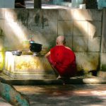 Burma, Mandalay  Maha Ganayon Kyaung Monastery; washing his eating bowl