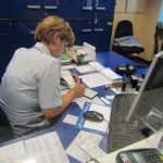 Croatia, Zagreb: train station agent hand writing our tickets