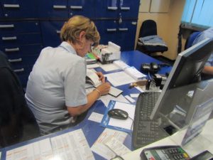 Croatia, Zagreb: train station agent hand writing our tickets